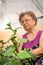 Elderly caucasian woman gardener in greenhouse