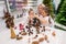 Elderly caucasian woman making pine cones decoration for christmas with two granddaughters