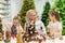Elderly caucasian woman making pine cones decoration for christmas with two granddaughters
