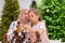 Elderly caucasian woman making pine cones decoration for christmas with two granddaughters