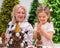 Elderly caucasian woman making pine cones decoration for christmas with two granddaughters