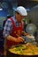 An Elderly Chef cooking at the popular Yuan Huan Bian Restaurant famous for its oyster omelette