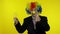Elderly clown businesswoman in wig show light bulb. Came up with great idea
