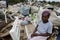 Elderly collecting waste for recycling