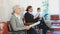 Elderly confident woman is sitting in the lobby of a large company, waiting for her turn to see a specialist in the