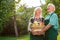 Elderly couple and apple basket.