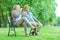 Elderly couple blowing bubbles in park