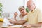 Elderly couple calculating costs of household. Senior people wit