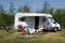 An elderly couple with camper