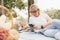 Elderly couple of caucasian using smartphone together in the park, Senior couple relax in summer daylight. relaxing concept of lif