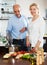 Elderly couple cooking vegetarian soup