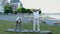 An elderly couple does gymnastics in a city park. Sports life in retirement