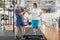 Elderly couple enjoying together workout at gym.