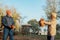 Elderly couple happily throws autumn fall leaves sitting in a park. Positive emotions of the elderly