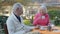 Elderly couple having breakfast outdoor. Mature people retired