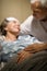 Elderly couple holding hands at clinic ward