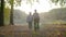 Elderly couple holding hands while walking together in park . Senior couple on a walk in autumn nature. Happiness people