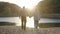 Elderly couple holding hands while walking together in park . Senior couple on a walk in autumn nature. Happiness people