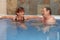 Elderly couple at hot water pool smiling