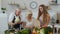 Elderly couple in kitchen receiving vegetables from grandchild. Raw food healthy eating diet