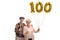 Elderly couple with lollipops and a golden number hundred balloon