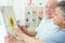 Elderly couple looking at painting sunflower