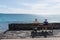 Elderly couple looks at the sea and sitting on a bench