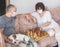 Elderly couple in medical masks during the pandemic coronavirus play chess