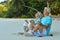 Elderly couple meditate on beach