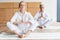 elderly couple performing namaste gesture and meditating together on yoga