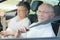 Elderly couple putting seat belt