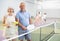 Elderly couple with rackets and balls posing on pickleball court