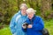 An elderly couple review photographs on the back of a DSLR camera