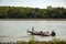 An elderly couple is seen on a red Phoenix bass fishing boat