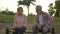 Elderly couple sitting on bench, sad man looking at his upset wife, quarrel