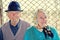 Elderly couple sitting together on a country road