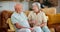 Elderly couple, sofa and talking in living room for conversation, bonding and discussion in morning. Relax