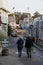 Elderly couple strolling down a quiet, empty street