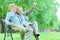 Elderly couple taking a selfie in the park