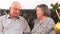 Elderly couple talking near Christmas tree