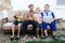 Elderly couple with their grandchildren in the yard of a village house