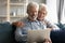 Elderly couple using laptop enjoy virtual entertainment