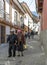 An elderly couple walk down a street in the old town section of La Paz in Bolivia.