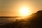 Elderly Couple Walking On Afternoon Sunset Beach