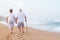 Elderly couple walking on beach