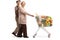 Elderly couple walking and pushing a shopping cart with food products