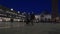 An elderly couple walks through the Piazza San Marco in the late evening. Venice