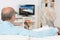 Elderly couple watching television