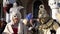 An elderly couple wearing Venetian costumes holding hands In the Venice Carnival