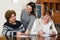 Elderly cute smiling women making will at notary office